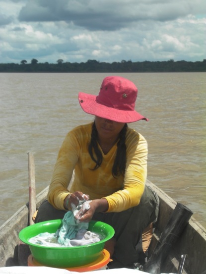 washing clothes on canoe Amazon river 